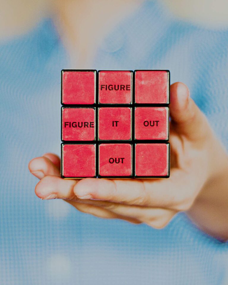 A Rubik's cube with the red side in the image and 'figure it out' spelled in the middle cross cubes across and downwards.